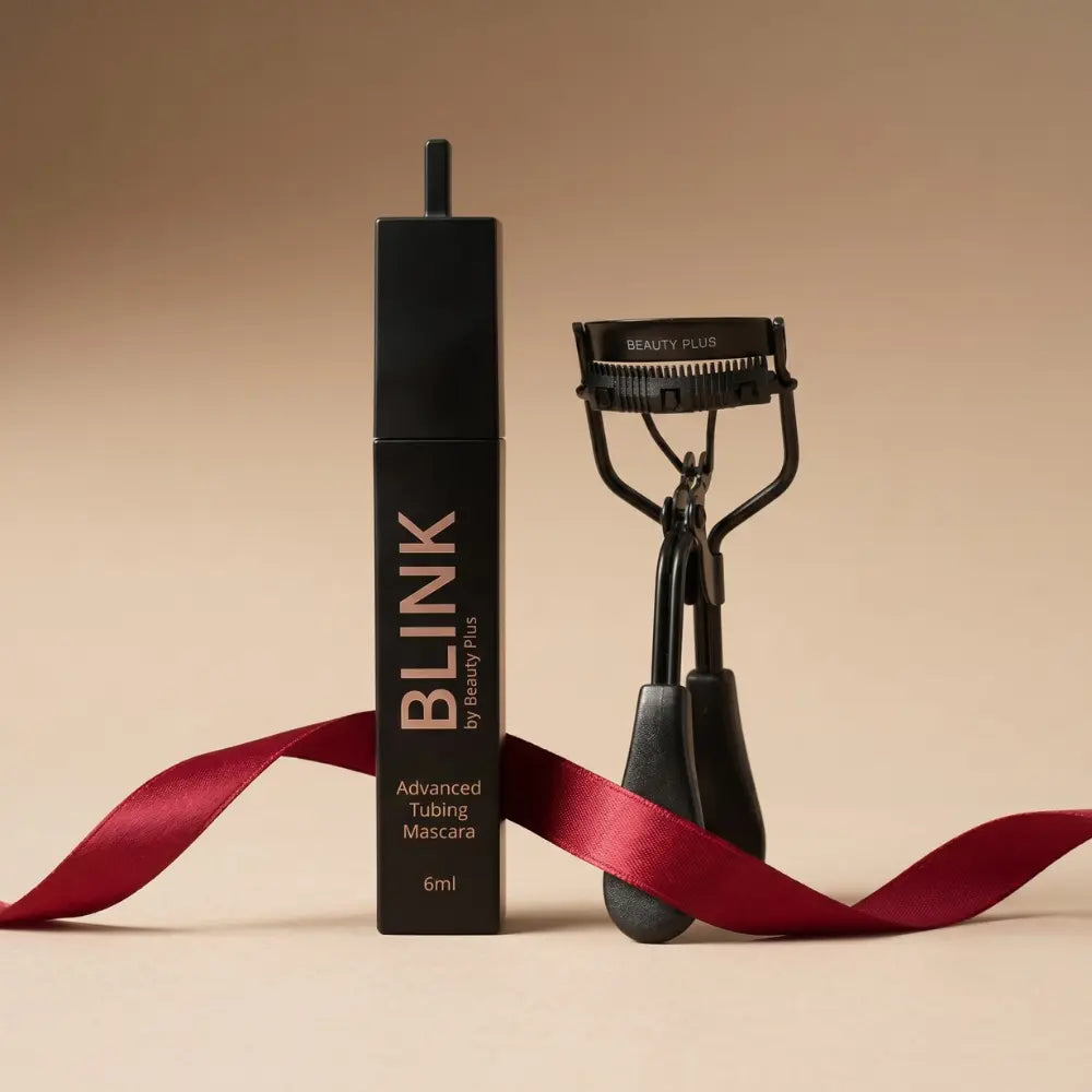 Lash Duo by Beauty Plus — BLINK® Advanced Tubing Mascara 6ml and LIFT® Lash Curler styled with a red satin ribbon on a beige background.