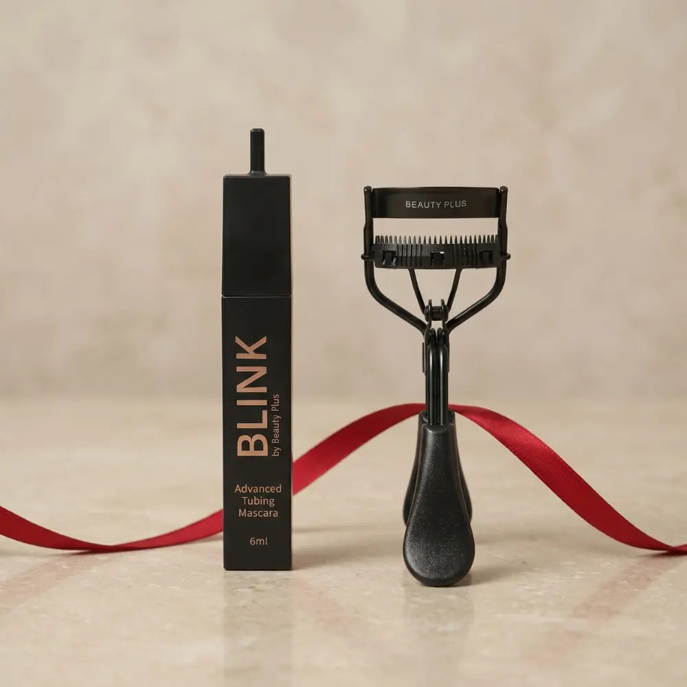 Lash Duo by Beauty Plus – BLINK Advanced Tubing Mascara 6ml and black eyelash curler set, styled with a red ribbon on a beige background.