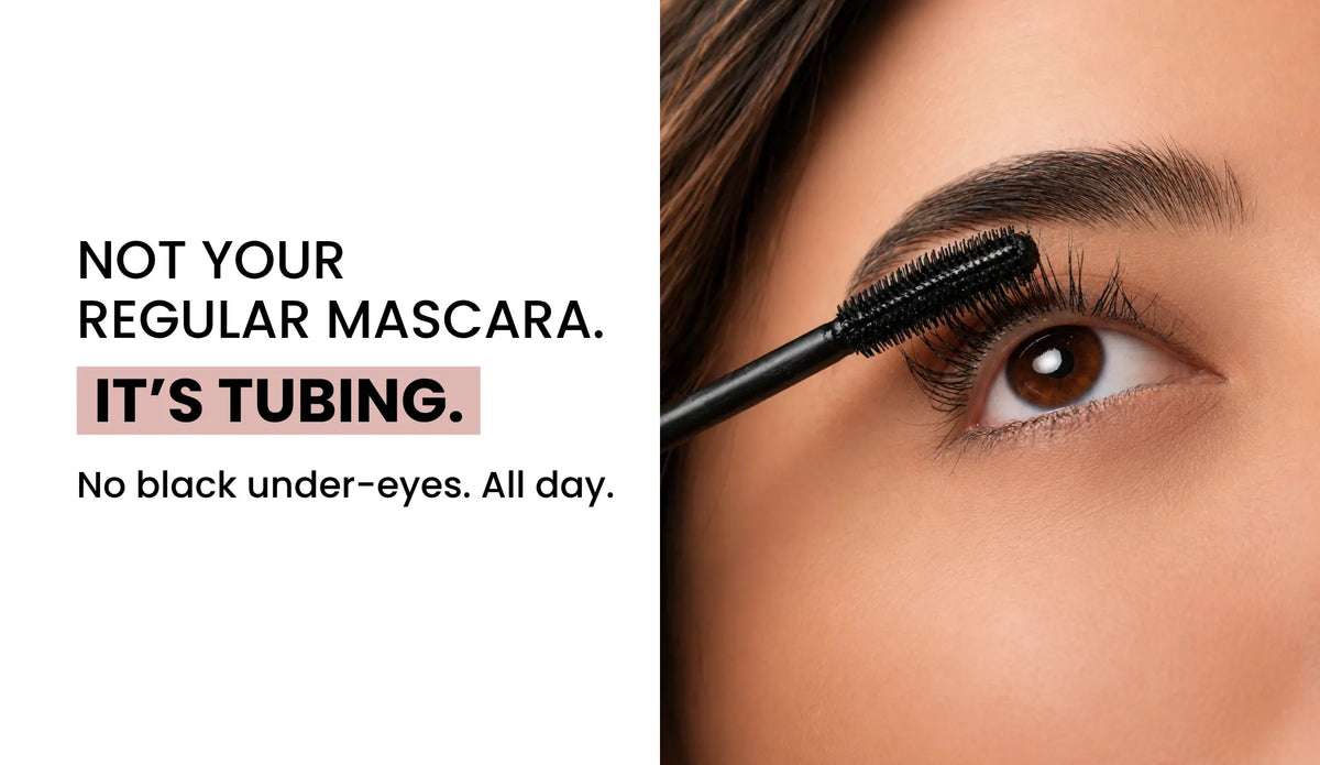 Close-up of a woman's brown eye with BLINK® tubing mascara being applied, alongside the text "Not your regular mascara. It's tubing. No black under-eyes. All day.